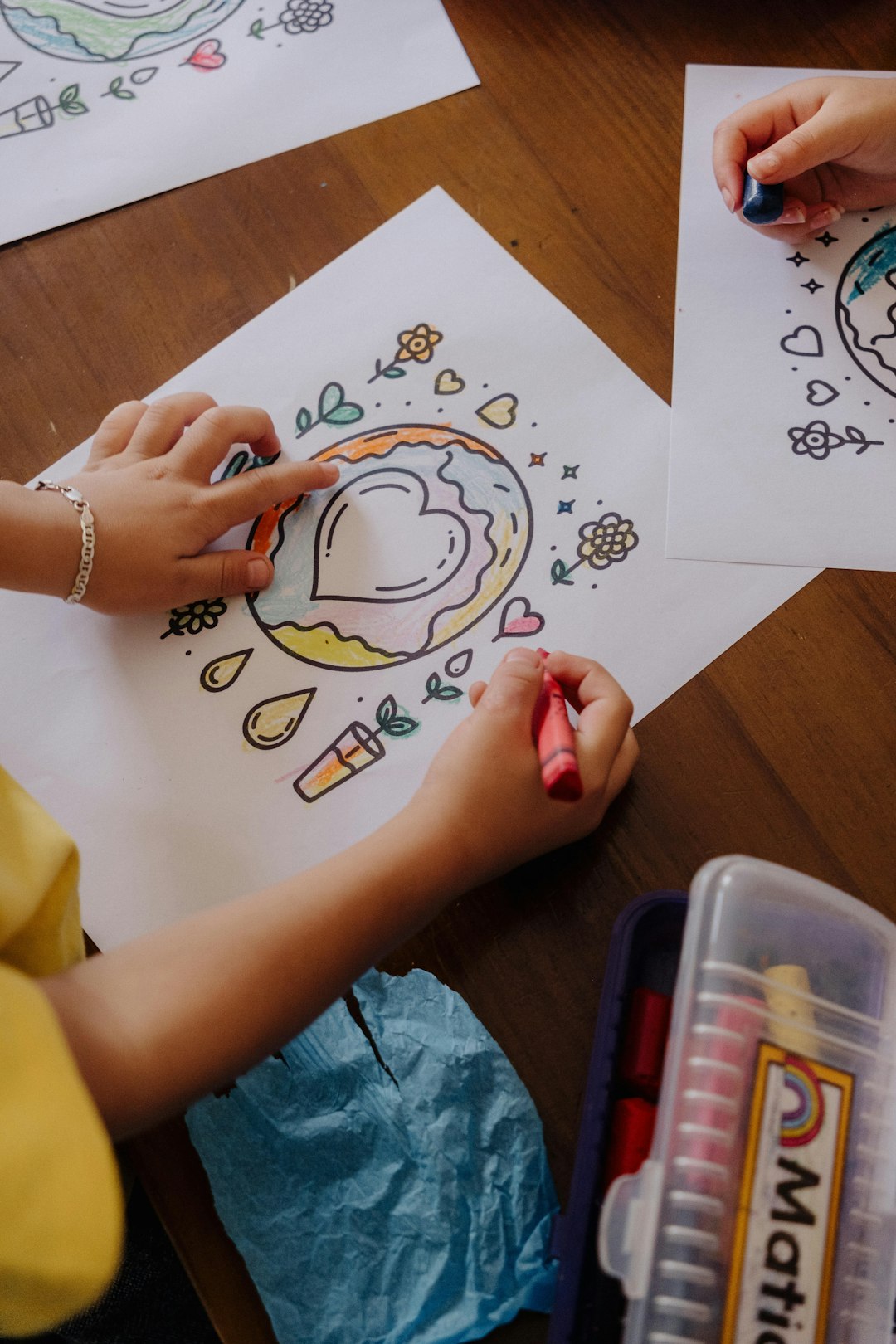 a-child-is-drawing-on-paper-with-crayons-hpsyrftkjd8