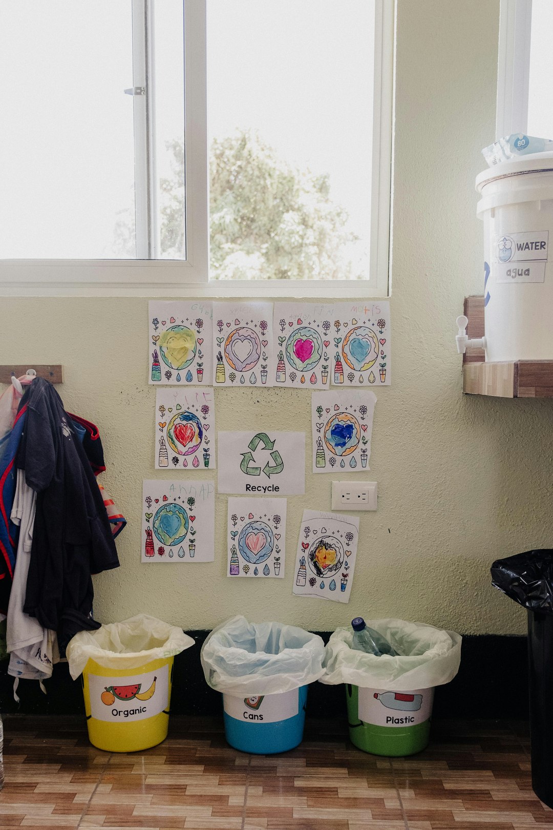 a-room-with-several-buckets-and-clothes-hanging-on-the-wall-xz9phzdq3ym